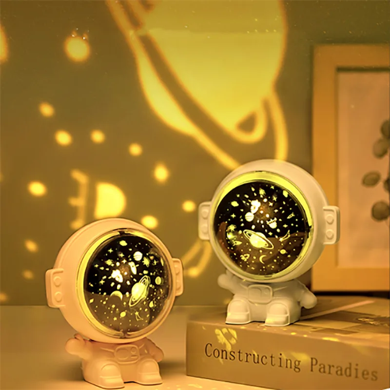 Astronaut projector lighting up a room with warm star projections